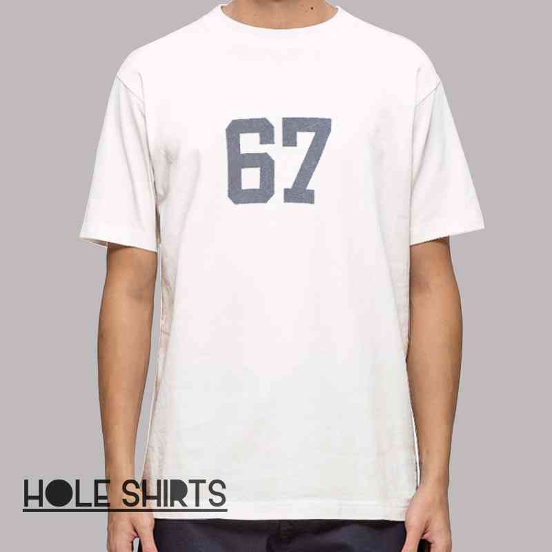 Number 67 graphic t-shirt featuring minimalist varsity style design, trendy streetwear number tee, casual fashion apparel for everyday wear, modern aesthetic clothing for men and women.
