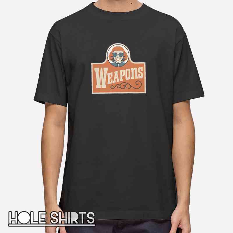 Graphic t-shirt featuring a poster-style design inspired by Zach Cregger’s Weapons aesthetic with retro fast food parody theme, bold cinematic artwork, pop culture streetwear apparel.