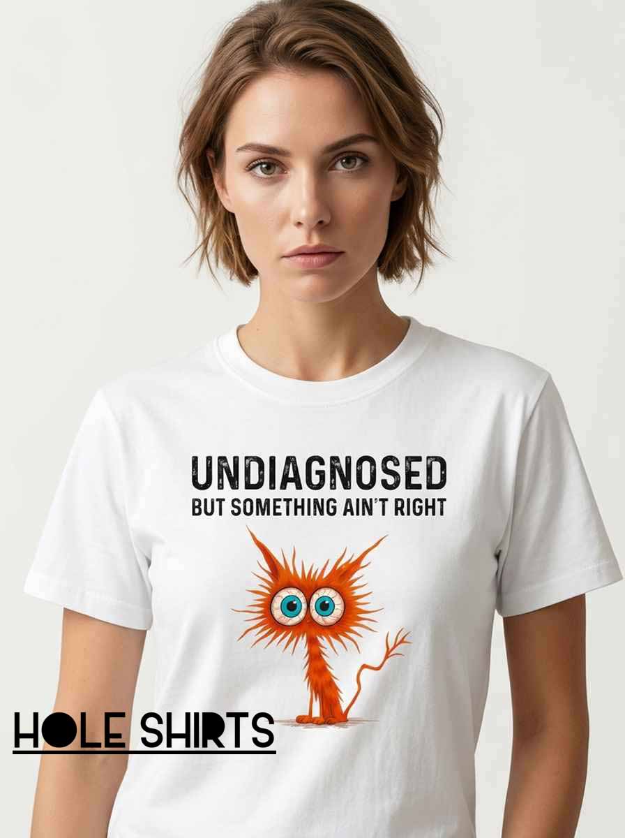 Something Ain’t Right Frazzled Cat Shirt featuring a chaotic, wide-eyed cat graphic with relatable humor, perfect for cat lovers, fans of funny feline memes, quirky animal T-shirts, and expressive casual streetwear.